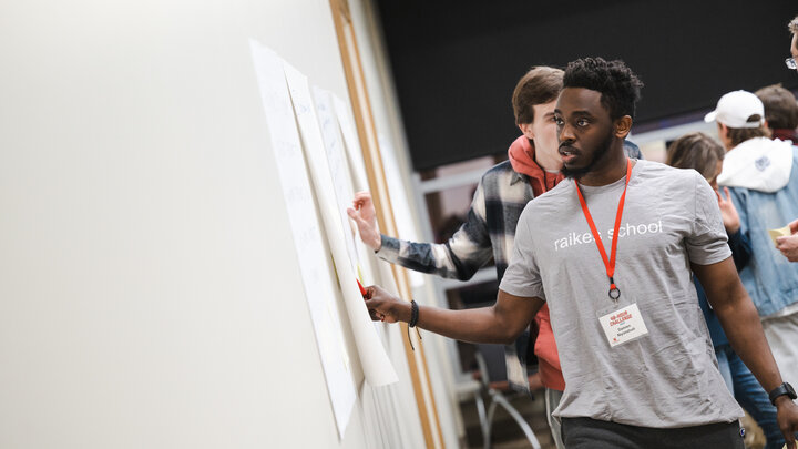 Damien Niyonshuti casts his vote for one of his favorite ideas during the opening evening of the 48-Hour Challenge