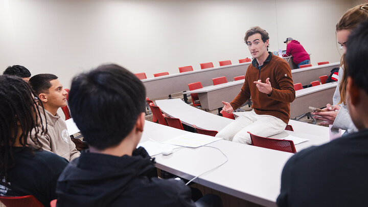 Connor Utech talks with a team