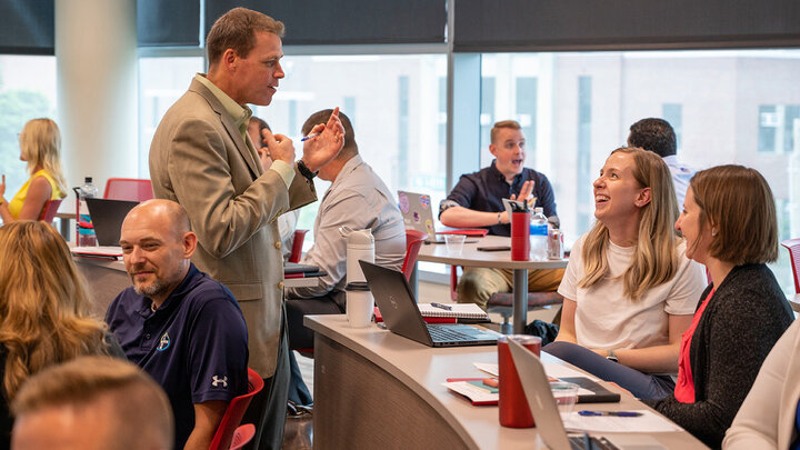 Online MBA students came to campus at the University of Nebraska-Lincoln to learn more about adaptive leadership. Part of a graduate course taught by Jake Messersmith (center), associate professor of management, they met with peers to create leadership plans to tackle organizational problems.