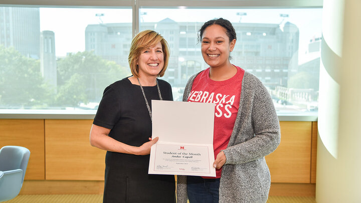 Dean Kathy Farrell presents Andee Capell, senior accounting major from Sioux Falls, South Dakota, with the Student of the Month certificate.