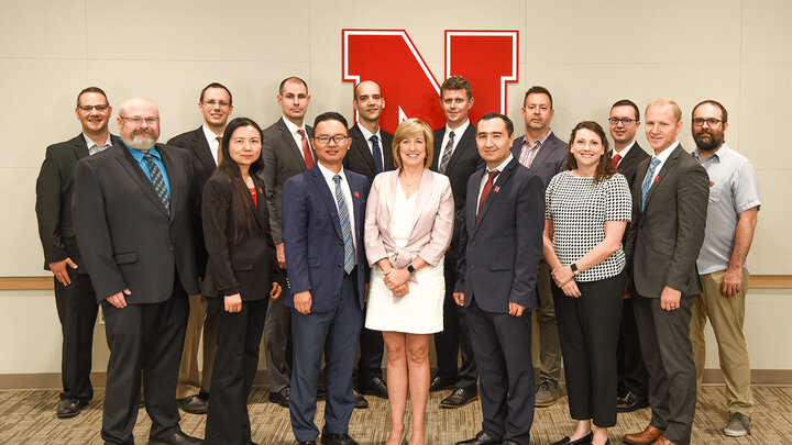 Dean Kathy Farrell with the 14 new faculty joining the College of Business this fall.