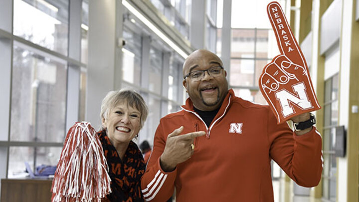 D’vee Buss and Mark Davis tout their school spirit in Husker apparel.