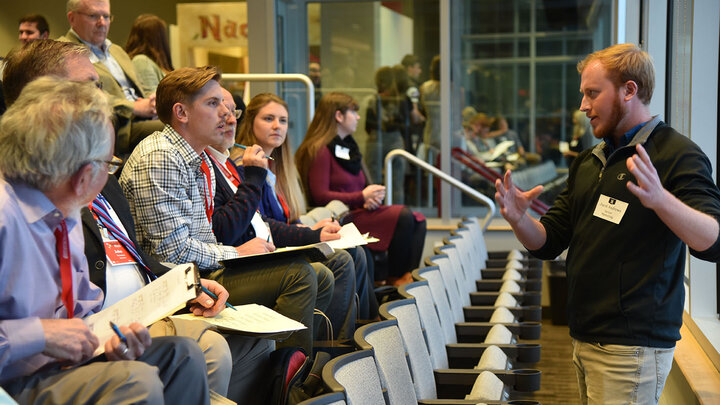 Students present three-minute quick pitches on new business ventures to a panel of judges.