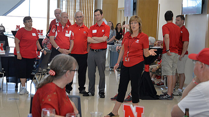 Dean Kathy Farrell welcomes fans to the Nebraska Business Alumni Tailgate last year.
