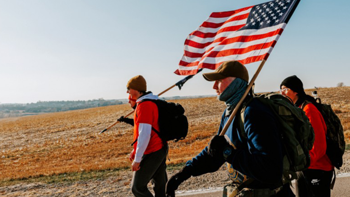 Midshipman Cohan Bonow and Ruck Marchers walk along Holdrege Street in eastern Lancaster County.