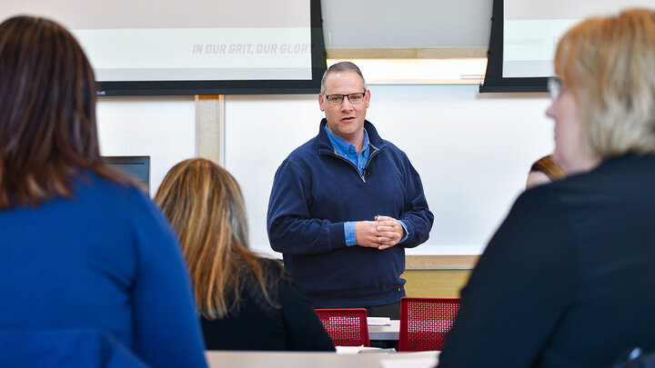 Tim Hodges talking in front of an Audience