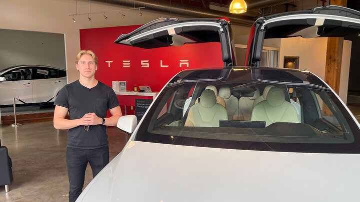 Jonathan Gerdes standing next to a Tesla