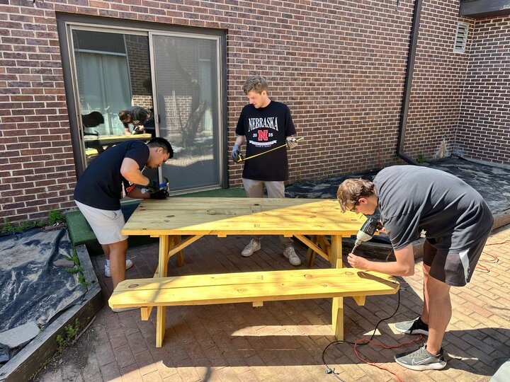Students volunteered at 12 nonprofits and did projects like assembling a picnic table for Dimensions Educational Research Foundation.