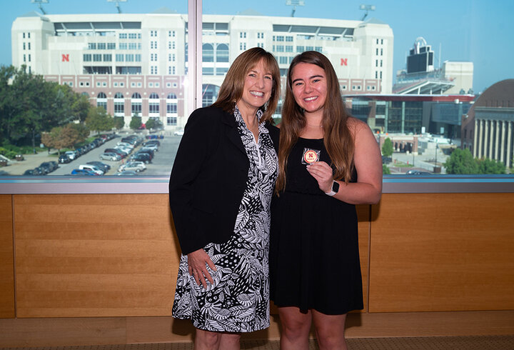 Management major Madelyn Kolar receiving a Dean's Coin