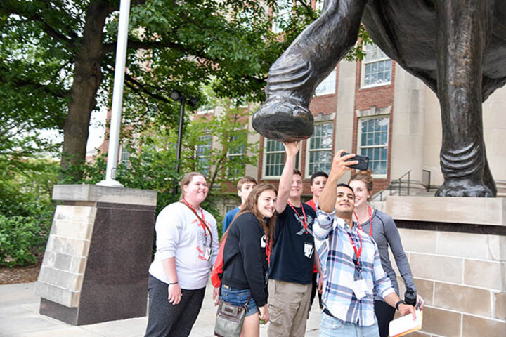 Fares Afshoonkar, ’18 and ’19, takes a selfie with Accounting Summit students during a scavenger hunt around campus.