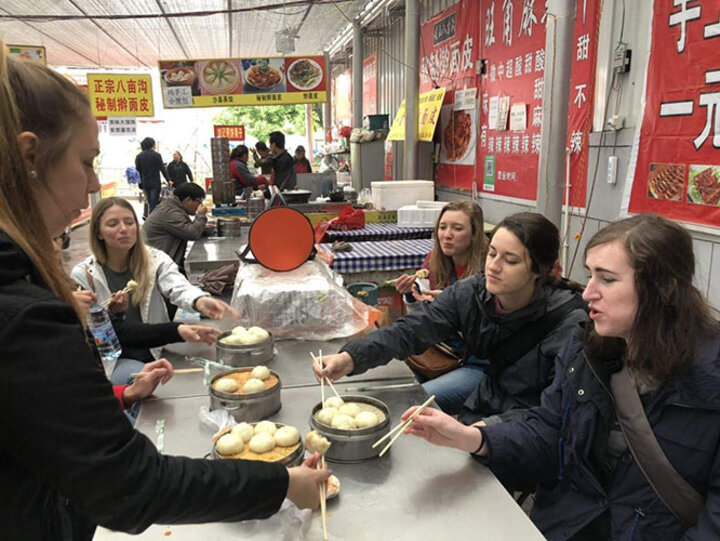 Nebraska students try dumplings in the market in Yangling.