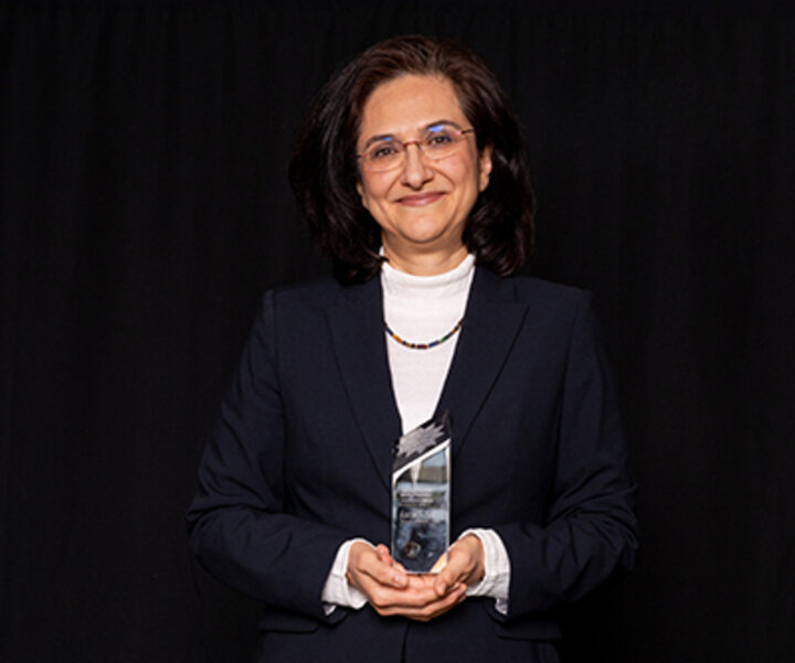 Esma Holding the Award