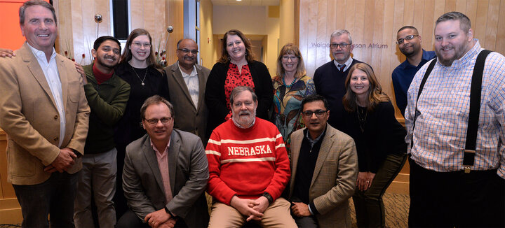 Gentry surrounded by a dozen of the students he advised during their Ph.D. programs at Nebraska.