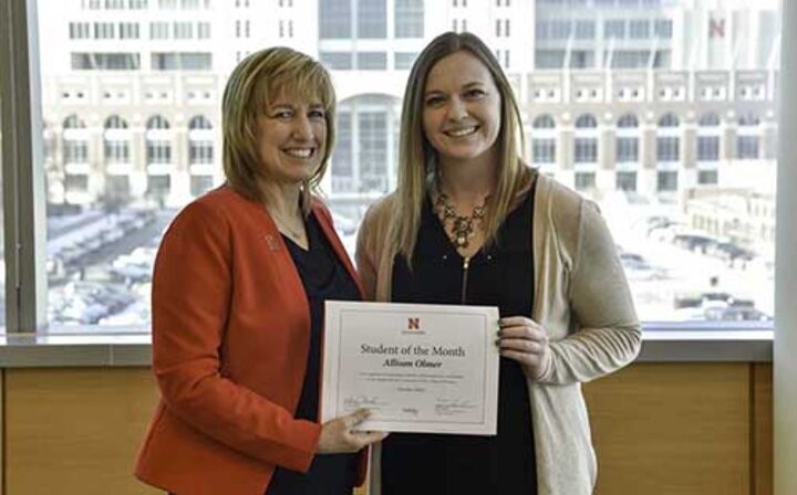 Allison Olmer receives a certificate proclaiming her the Nebraska Business Student of the Month from Dean Kathy Farrell.