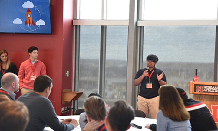 Dillon DeRozairo, a senior at Millard North High School, pitches his idea in the final round of the high school division.