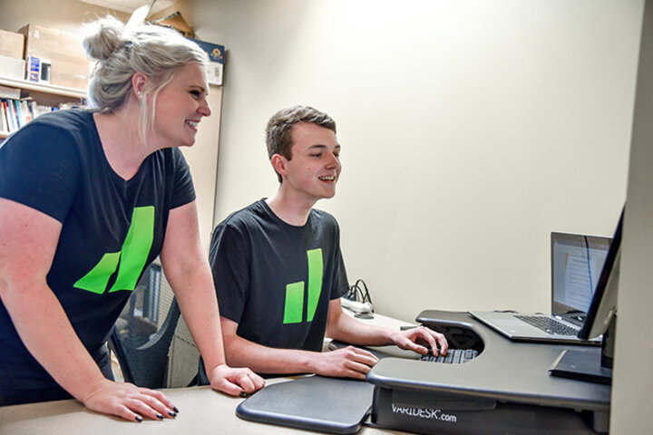 Newburn, working alongside Elise Rempel (left), turned his attitude around about school after finding motivation and connections in his work to class.