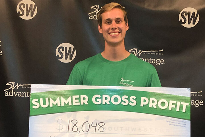 Nicholas Wiebelhaus holds his check for $18,048 from his summer in the Southwestern Advantage Program.